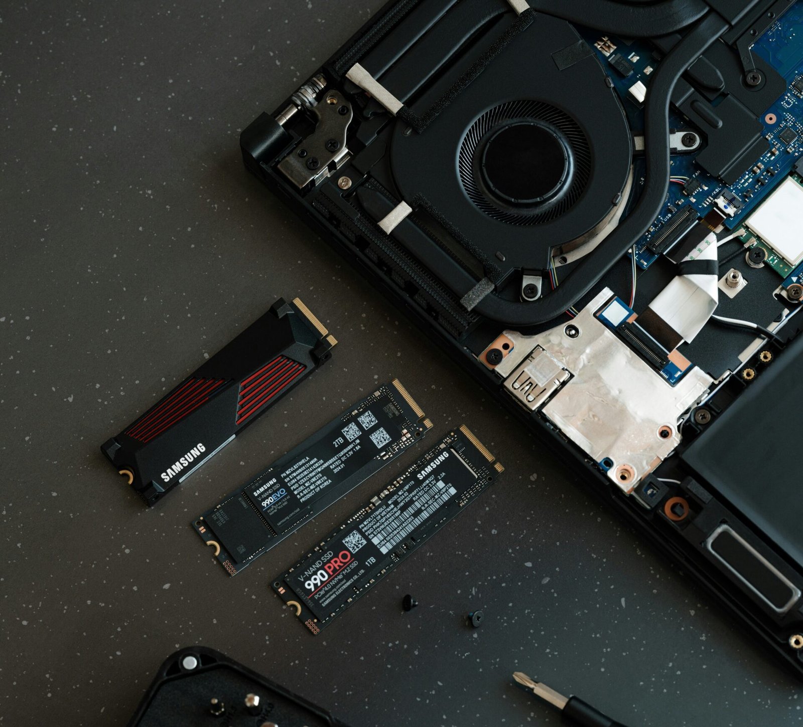 A broken laptop computer sitting on top of a table